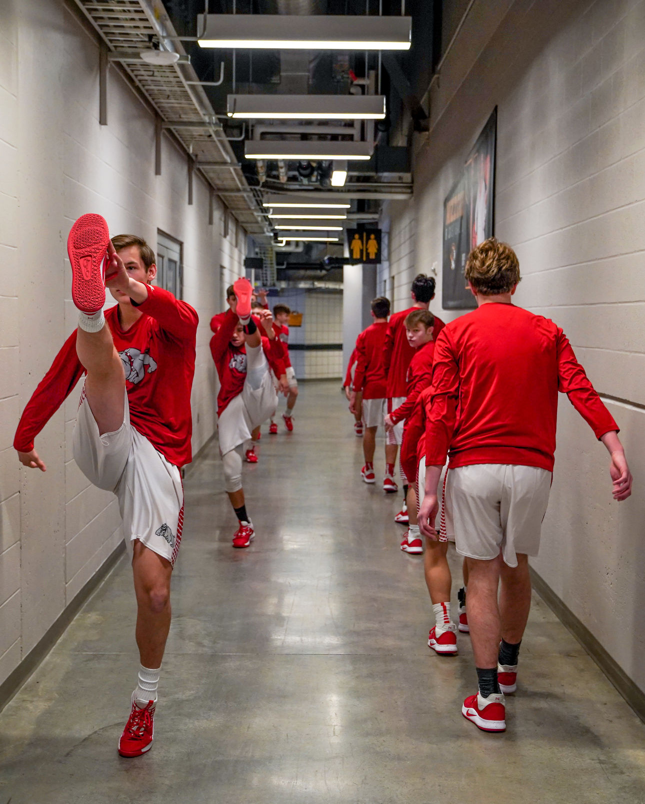 Players from Harrisburg Bulldogs stretch their legs with a high kick warm up